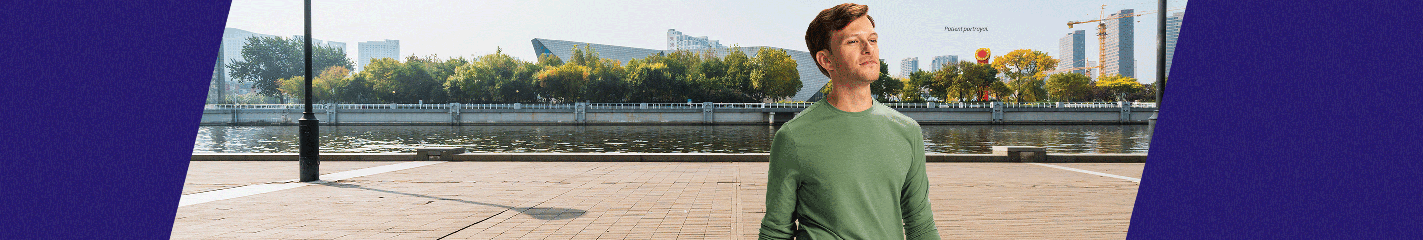 Man with rolling suitcase outdoors (patient portrayal)